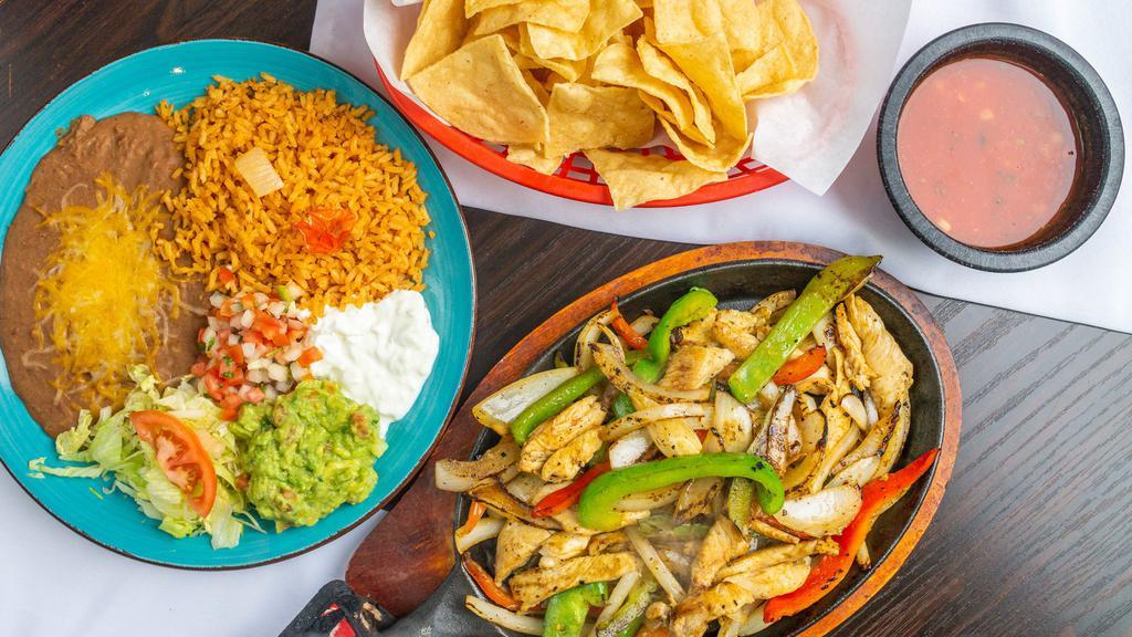 Fajitas · Choice of meat sautéed with onions and bell peppers and our special marinade, guacamole and sour cream. Choose corn or flour tortillas