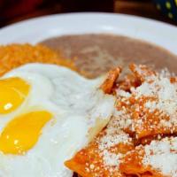Chilaquiles · Tortilla chips cooked in red sauce and sprinkled with Mexican cheese. Served with two eggs, ...