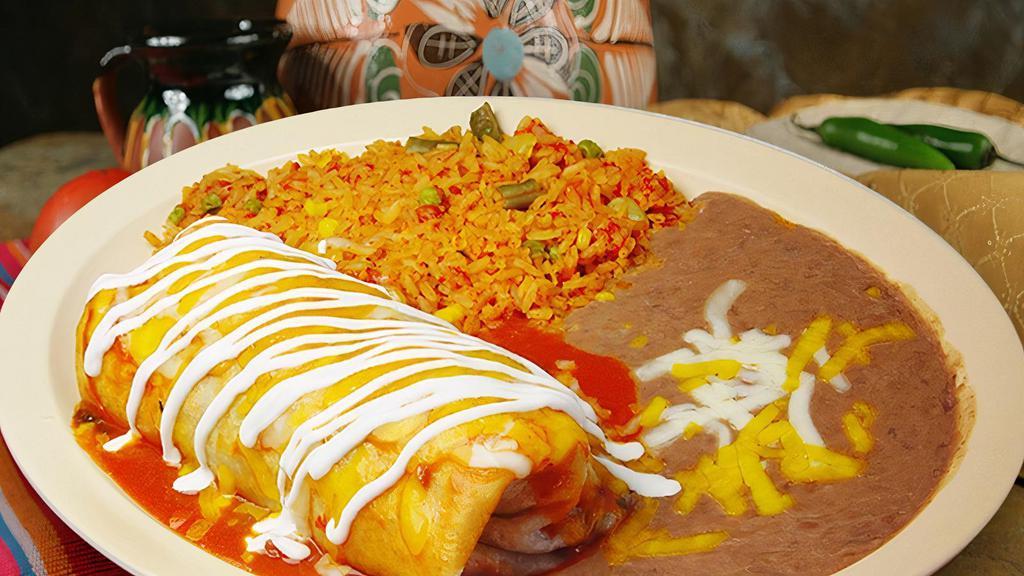 Burrito Plate · A burrito filled with your choice of meat, cilantro, and onion, then drenched in salsa ranchera and sour cream. Served with rice and beans on the side.