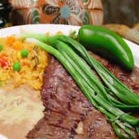 Carne Asada · Our famous steak served with rice, beans, grilled jalapeno pepper, grilled onions, choice of...