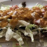 Huarache · Similar to sopes, huaraches are a deep fried masa base topped with your choice of meat, lett...