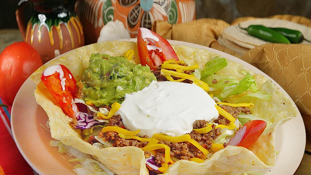 Taco Salad · Deep-fried tortilla filled with your choice of meat, beans, cheese, lettuce, tomato, sour cream, and guacamole.