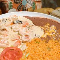 Camarones A La Crema · Shrimp sautéed in a white sauce with mushrooms and onion and served with rice, beans, your c...