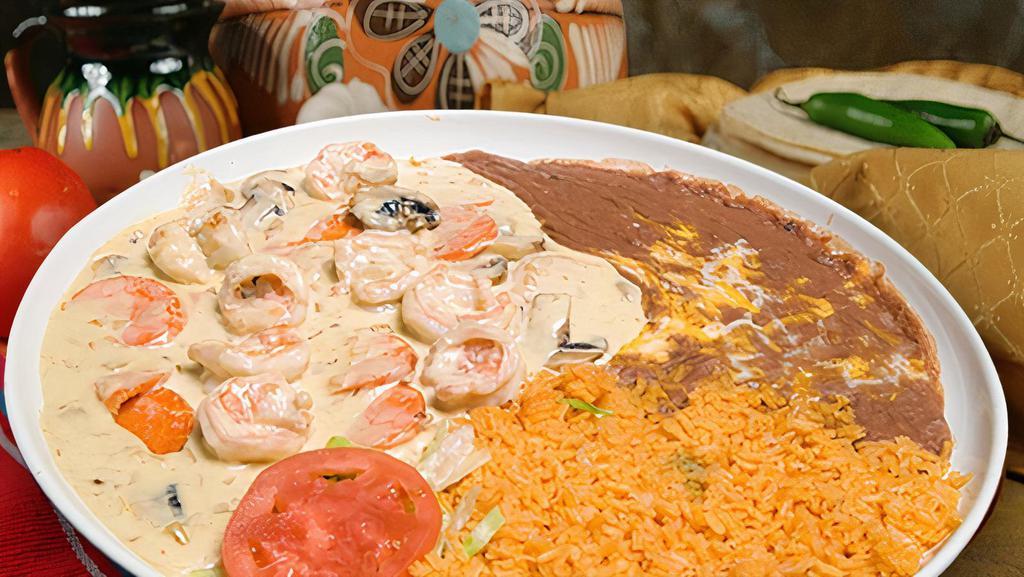 Camarones A La Crema · Shrimp sautéed in a white sauce with mushrooms and onion and served with rice, beans, your choice of tortilla, and a side salad.