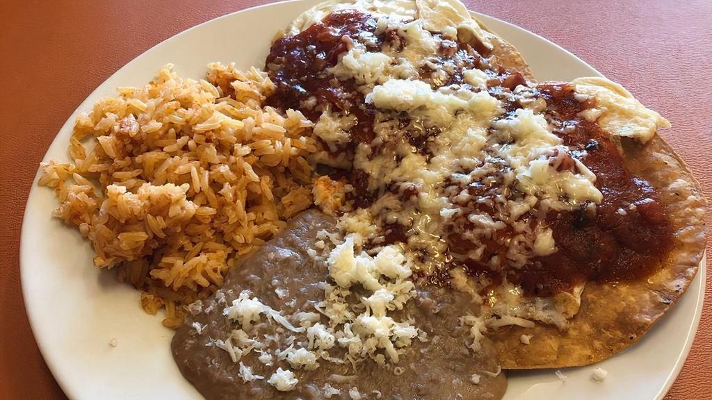 Huevos Rancheros · Two Sunny side-up eggs on fried tortillas, covered with warm salsa and your choice of two sides.