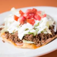 Tostada · Deep-fried corn tortilla, topped with your choice of meat, beans, lettuce, cheese, sour crea...