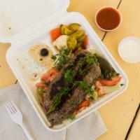 Kofta Over Salad Platter · Grilled ground beef made with Egyptian spices drizzled with tahini sauce on top of salad. Pi...