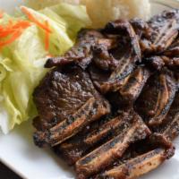 Beef Short Ribs · Served with rice and salad.