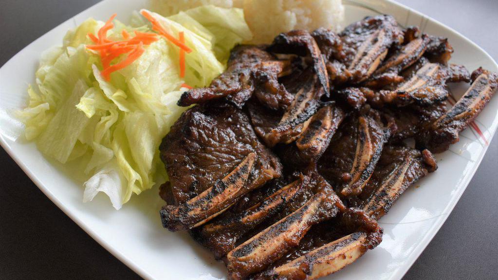 Beef Short Ribs · Served with rice and salad.
