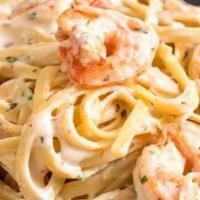 Shrimp Fettuccine · Fettuccine sautéed with shrimp, sun-dried tomatoes, and garlic in Alfredo sauce. Placed on a...