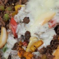 Beef Philly Cheesesteak · Sautéed ribeye steak, grilled onions, and multiple color bell peppers, topped with melted Am...