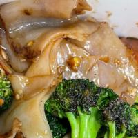 Pad See Ew · Wide-size rice noodles with egg, broccoli, and carrots.