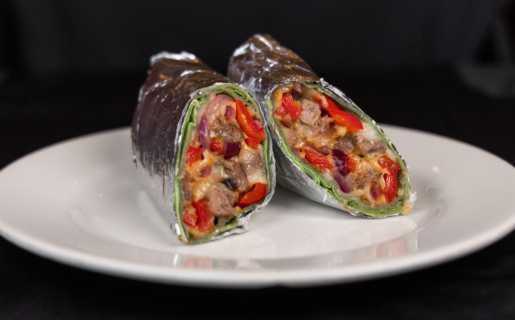 Philly Cheese Steak · Robust flavors of pepper, onion, and grilled steak- mixed with melted cheese rolled up in soft spinach wrap.