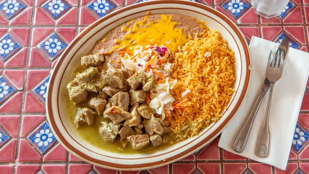 Chile Verde · Tender pieces of grilled steak topped with homemade verde salsa with a side of rice and beans.
