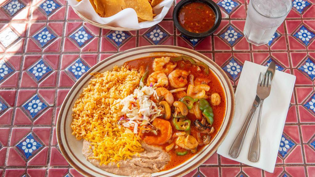 Camarones A La Diabla · Grilled shrimp cooked with onions and diabla sauce, served with rice, beans and a side of tortillas.