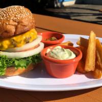 Cheeseburger And Yuca Fries. · Beef patty, american cheese, lettuce, tomato, onion, house made pickles, burger sauce. Serve...