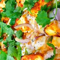 Paneer Tikka Pizza · Homemade paneer (cottage cheese), red onions, bell peppers, fresh spinach and cilantro on ou...