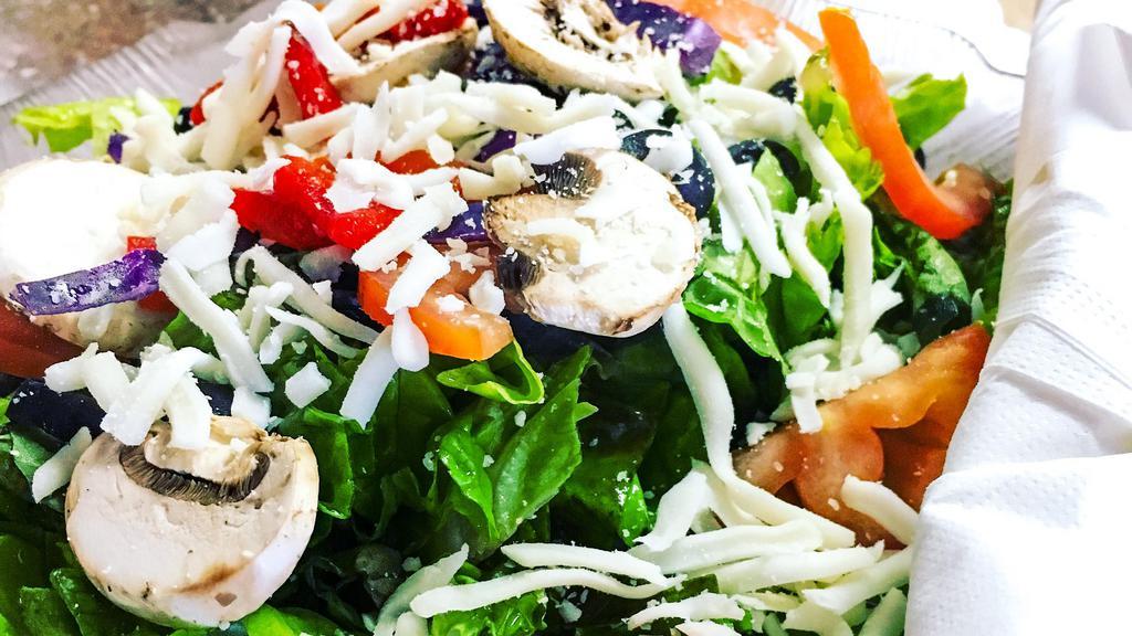 Italian Green Salad · Red leaf lettuce, red cabbage, roma tomatoes, black olives, mushrooms, roasted sweet red peppers, mozzarella and Parmesan cheese. Comes with two bread sticks and your choice of house Italian, ranch or bluecheese dressing.