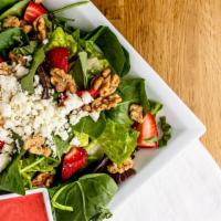 Strawberry Salad · Mixed greens and fresh spinach with strawberries, caramelized walnuts, feta cheese, fresh ba...