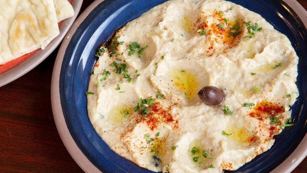 Baba Ghannooj · Aromatic eggplant dip garnished with parsley, paprika, and topped with olive oil upon request.