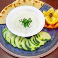 Tzatziki · A refreshing cucumber yogurt dip made from scratch served with your choice of pita bread, ch...