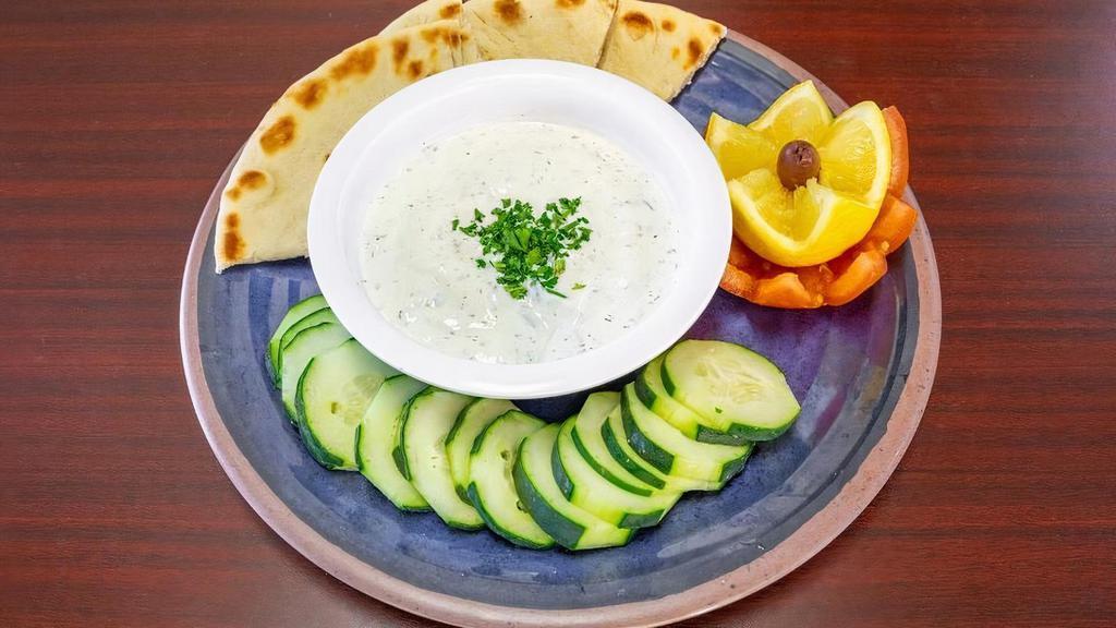 Tzatziki · A refreshing cucumber yogurt dip made from scratch served with your choice of pita bread, chips or refreshing veggies.