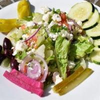 Greek Salad · A bed of salad with tomato, cucumber, onions, kalamata olives, feta, and assorted Mediterran...