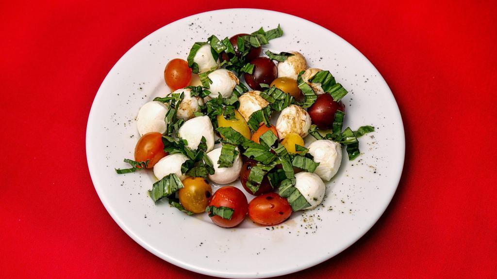Insalata Caprese · Slices of fresh mozzarella cheese, slices of roma tomatoes, fresh basil, pepper and extra virgin olive oil.