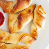 Breadsticks · 5 pieces. Served with red sauce for dipping.