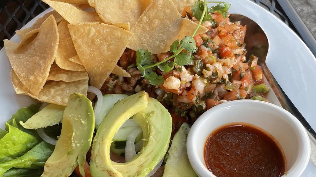 Shrimp Ceviche · Shrimp marinated in lime juice, jalapeños and tomato, served with fresh chips.