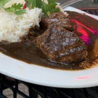 Mole Negro Oaxaqueño · The house specialty. Black mole with chicken or pork served with white rice and two fresh to...