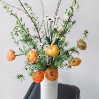White Vase Arrangement · Seasonal flowers arranged in a white vase.