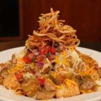 Tater Greens · Crispy tater tots smothered with cheddar & Monterey jack, veggie green chili, pico de gallo,...