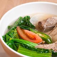 Pork Sinigang · Cooked in tamarind-based soup with mustard green, daikon radish and long beans.