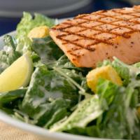 Caesar Salad With Grilled Wild Alaskan Salmon · Wild Alaskan Salmon Filet served on a Caesar Salad with croutons, Parmesan Cheese and Caesar...