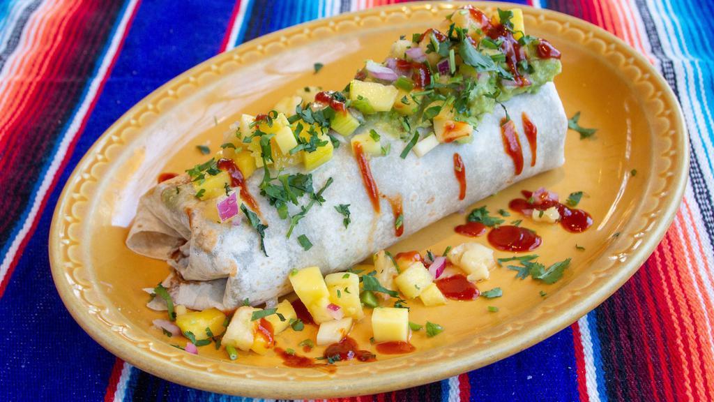 Brazilian Steak Burrito · Spicy Brazilian beef with grilled onions, chipotle sauce, beans, rice, guacamole + fruit salsa.