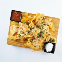 Nachos · tortilla chips, cheese, green onions, fire-roasted jalapenos, diced tomatoes, diced onions, ...
