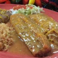 Combo 2 (2 Smothered Tamales) · Two homemade tamales smothered in our signature green chili with rice and beans.