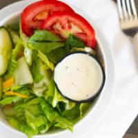 Tossed Green Salad · Served with dressing.