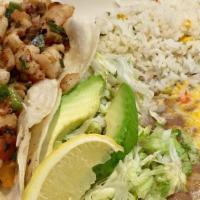 Fish Taco Combo · 2 Fish tacos  on flour tortilla with beans and spanish rice.