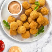 Tater Tots Tower · Shredded Idaho potatoes formed into tots, battered, and fried until golden brown. Served wit...