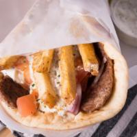 Traditional Gyro · Three strips of beef and lamb gyro meat, tomatoes, onions, tzatziki sauce, and a few fries w...