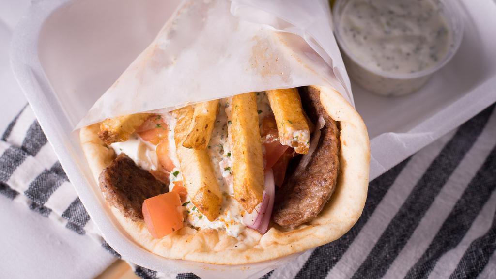Traditional Gyro · Three strips of beef and lamb gyro meat, tomatoes, onions, tzatziki sauce, and a few fries wrapped in a seven inches pita. Served ala carte.