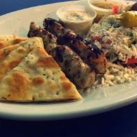 Chicken Souvlaki · Two skewers of chicken breast, small greek salad, pita and tzatziki, and your choice of frie...