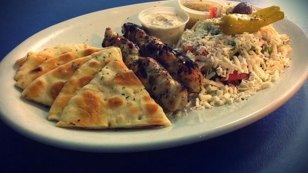 Chicken Souvlaki · Two skewers of chicken breast, small greek salad, pita and tzatziki, and your choice of fries or rice