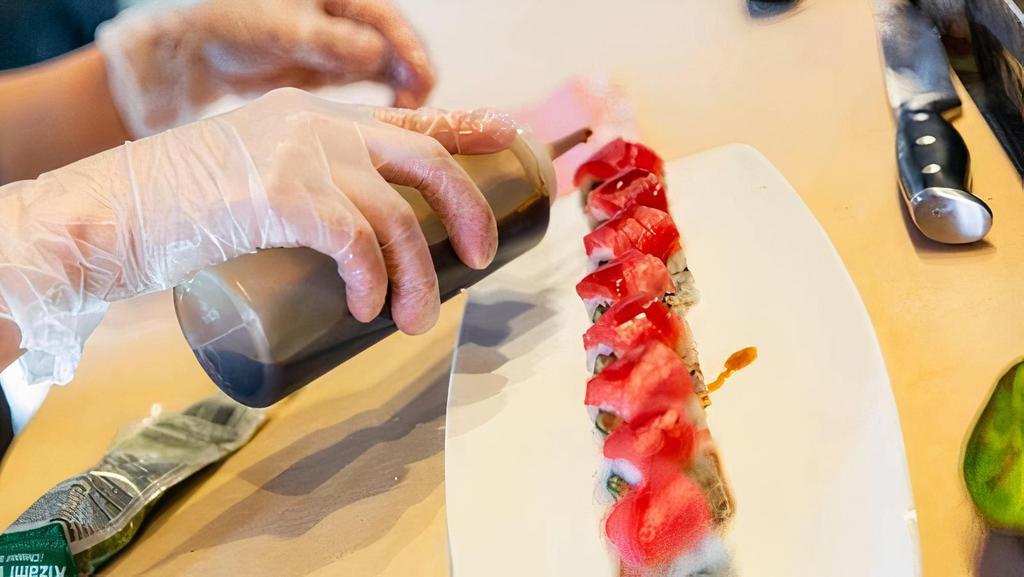 Sport Lover'S Roll · Jumbo lumb crab, avocado, tempura crunch, soy paper-topped with sliced tuna, spicy mayo.