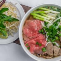 Pho Vegas Dac Biet · Special-noodle soup with rare steak, crunchy flank, triple tendon, brisket, meatball.