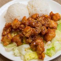 Volcano Chicken · Deep fried marinated chicken with sweet chili house sauce serve on top of lettuce with rice.