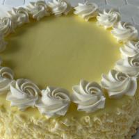 Luscious Lemon Torte · Lemon cake cake with lemon jelly and lemon Swiss butter cream filling. Iced in vanilla Swiss...
