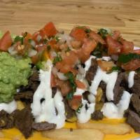 Carne Asada Fries · Grilled steak, nacho cheese, sour cream and guacamole